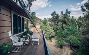 a balcony with chairs and plants on a house at Quiet Mind Lodge, Spa & Retreat Sequoias in Kernville
