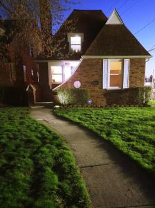 a brick house with a sidewalk in front of it at Vintage Charm, E. Eng. Village, 10mins to Dt. Det. in Detroit