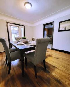 a dining room table and chairs in a living room at Vintage Charm, E. Eng. Village, 10mins to Dt. Det. in Detroit