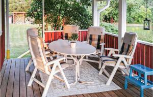 a table and four chairs on a porch at Beautiful Home In Sunnemo With Wifi And 2 Bedrooms in Sunnemo