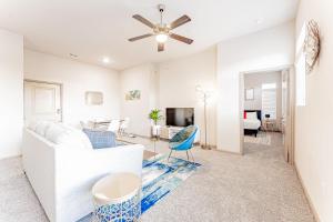 a living room with a white couch and a ceiling fan at Spacious 2BR King Bed Suites Close to Downtown and Airport in Austin