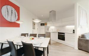 a dining room and kitchen with a white table and chairs at Highend Travemünde - Whg 214 in Travemünde