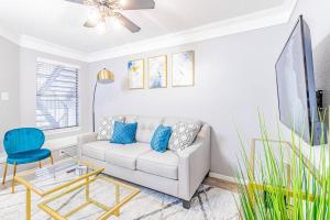a living room with a couch and a blue chair at Central 1BR King Bed Suites, Close to Downtown & Domain in Austin