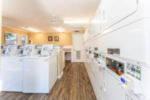 a laundry room with white appliances and wooden floors at Central 1BR King Bed Suites, Close to Downtown & Domain in Austin +10 photos