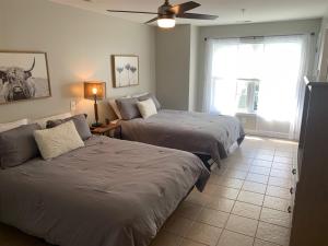 a bedroom with two beds and a ceiling fan at 2504 Commons II in Calabash