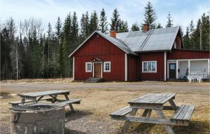 two picnic tables in front of a red barn at 5 Bedroom Pet Friendly Home In Sdra Rdom 