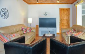 a living room with two couches and a flat screen tv at 5 Bedroom Pet Friendly Home In Sdra Rdom 