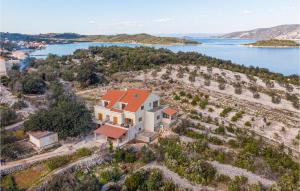 an aerial view of a house on a hill next to a lake at 1 Bedroom Cozy Apartment In Kneze in Pupnat