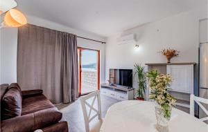 a living room with a couch and a table at 1 Bedroom Cozy Apartment In Kneze in Pupnat