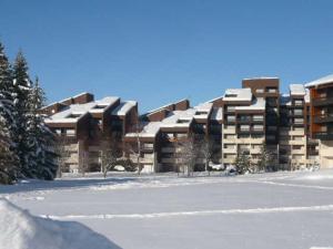 a large building with snow on top of it at Studio confortable au pied des pistes de Corrençon-en-Vercors avec balcon et proche du golf - FR-1-515-125 in Corrençon-en-Vercors