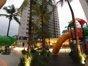 a resort with a water park with a slide and palm trees at Flat em Salinópolis no Salinas Premium Resort in Salinópolis