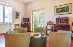 a living room with a table and chairs at Pet Friendly Home In San Piero In Campo With House Sea View in San Piero in Campo