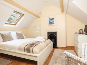 a bedroom with a bed and a fireplace at The Retreat in Dartmouth