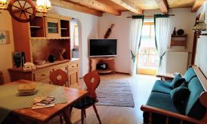 a living room with a blue couch and a table at Sulzenhof in Ruhpolding