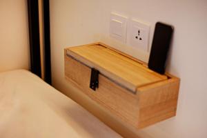 a wooden box sitting on the side of a bed at TRIBAL Coworking Bali in Canggu