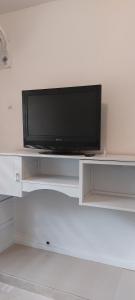 a flat screen tv sitting on top of a white entertainment center at Casa de Huespedes Villa Hermosa in La Vega