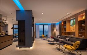 a living room with a couch and tables and chairs at Stunning Home In Omis With Kitchen in Omiš