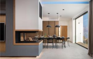 a kitchen and dining room with a table and a fireplace at Stunning Home In Omis With Kitchen in Omiš