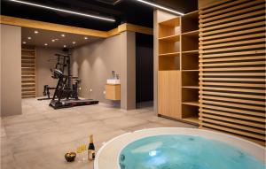 a gym with a large tub in a room at Stunning Home In Omis With Kitchen in Omiš +42 photos