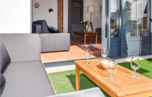 a living room with wine glasses on a table at 1 Bedroom Awesome Apartment In Noirmoutier-en-lle in Noirmoutier-en-l'lle