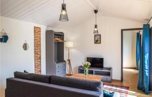 a living room with a couch and a tv at 1 Bedroom Awesome Apartment In Noirmoutier-en-lle in Noirmoutier-en-l'lle