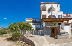 a white building with a staircase in front of it at Gorgeous Apartment In Stinica With Kitchen in Stinica