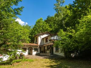 an old house in the middle of a forest at Spacious Holiday Home with shared pool in San Marcello Pistoiese
