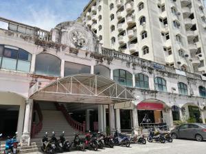 a group of motorcycles parked in front of a building at Fastbook Ferringhi SoHo unit 8pax in Batu Ferringhi