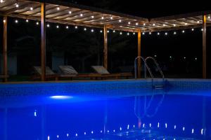 a swimming pool at night with lights above it at Casa Solaris in Ica