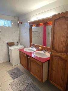 a bathroom with two sinks and a mirror and a toilet at CD House in Fort-de-France +34 photos