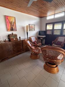 a living room with two chairs and a desk at CD House in Fort-de-France