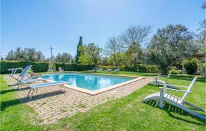 einen Pool in einem Garten mit zwei Bänken in der Unterkunft Amazing Home In Montalto Di Castro With Wifi in Montalto di Castro