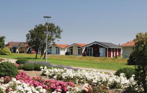 a row of houses in a park with flowers at Friedrichskoog-Deichblick 12 in Friedrichskoog +9 photos