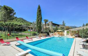 a swimming pool with chairs and a slide at Nice Home In Condorcet With Outdoor Swimming Pool, Private Swimming Pool And 5 Bedrooms in Condorcet