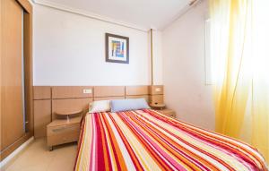 a bedroom with a bed with a colorful blanket at Gorgeous Apartment In Oropesa Del Mar in Oropesa del Mar