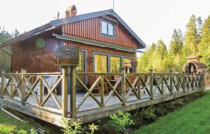 a house with a wooden bridge in front of it at Gorgeous Home In Skillingaryd With Kitchen in Starkeryd