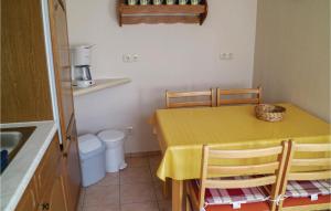 a small kitchen with a yellow table and chairs at Cozy Apartment In Marlow Ot Gresenhorst With Kitchen in Gresenhorst