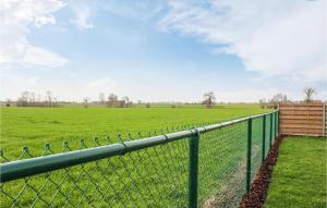 a chain link fence with a field in the background at Awesome Home In Stavele With Wifi in Stavele