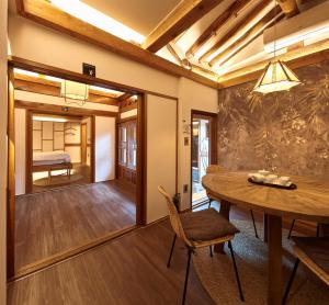 a dining room with a table and chairs and a bedroom at Luxury hanok with private bathtub - SN03 in Seoul