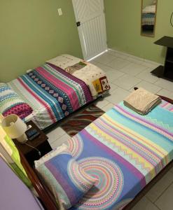 two beds sitting on the floor in a room at Posada Gordon Antonio in San Andrés