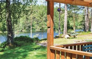a view of a lake from the porch of a cabin at 2 Bedroom Beautiful Home In Sävsjö in Griggatorp