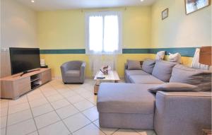 a living room with a couch and a tv at Lovely Home In Marcey-les-grves With Kitchen in Marcey-les-Grèves