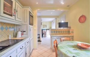 a kitchen with a table and a dining room at Lovely Home In Marcey-les-grves With Kitchen in Marcey-les-Grèves