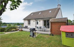 a house with a barbecue grill in the yard at Lovely Home In Marcey-les-grves With Kitchen in Marcey-les-Grèves
