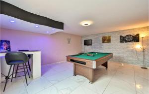 a room with a pool table and a bar at Lovely Home In Rivalno With Sauna in Slanje