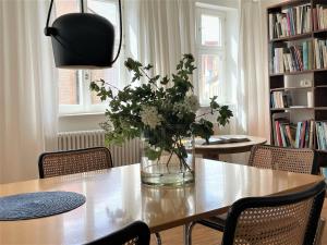 una mesa de comedor con un jarrón de flores. en kirchgässlein, en Dinkelsbühl