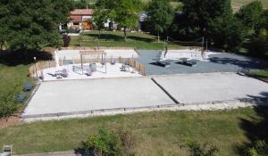 an aerial view of a skate park with a skateboard ramp at Camping des Tourbières - Gîtes in Vendoire