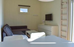 a living room with a couch and a tv at Lovely Home In Hasslö With Kitchen in Hasslö