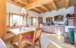 a kitchen with a wooden table and chairs at Amazing Home In Reinersdorf With 1 Bedrooms And Wifi in Woppendorf