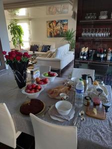 a living room with a table with food on it at Parisian Sparkle Retreat in Neuilly-sur-Seine